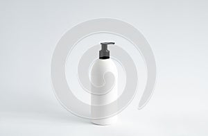 White blank plastic bottle with black dispenser pump for gel, liquid soap, lotion, cream, shampoo on white background