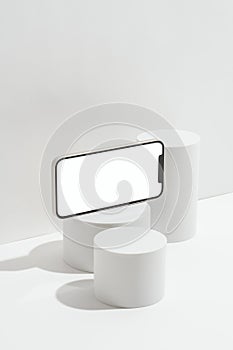 White blank screen smart phone mockup, template on geometric pedestal