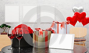 White blank screen tablet Put on a table with a gift box and a glass of wine For the celebration of the couple. A red rose to give