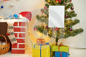 White blank sheet of paper against the background of the Christmas tree and the fireplace