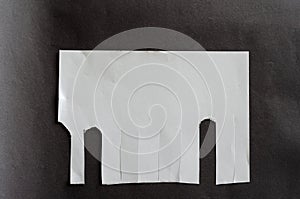 White blank sheet of paper with tear-off tabs on gray background