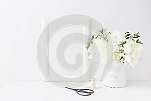 White blank wooden frame mockup. Wedding table still life composition with floral bouquet made of peony and Gypsophila photo