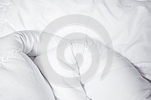 White blanket. Wrinkle messy blanket in bedroom after waking up in the morning. Bed details. Duvet and blanket, an unmade bed