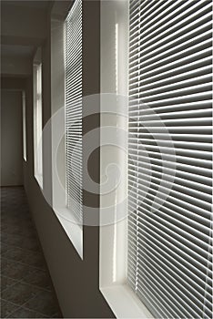 White blinds in dark corridor in perspective