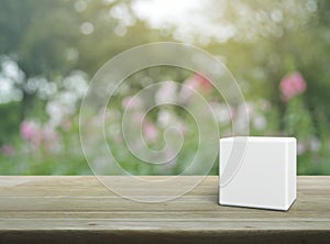 White block cube on wooden table