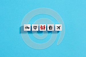 White blocks with insurance icons on blue background. Family, life, car, travel, health and house insurance