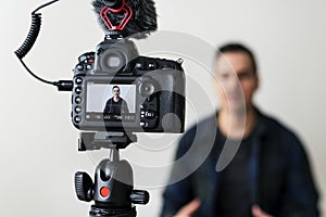 White blogger recording video using camera