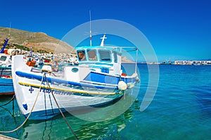 White-blue boat with Greek colors in bay, Greece photo