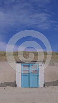 White and blue cabin on the beach