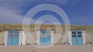 White and blue cabins on the beach