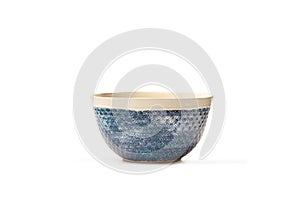 White and blue ceramic bowl on a white background with copy space