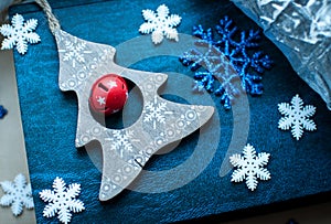 White and blue Christmas snowflakes decoration on blue and silver background.