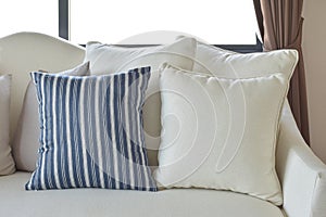 White and blue decorative pillows on a casual sofa in the living room