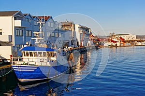 White and blue fishing boat at the wharf repair