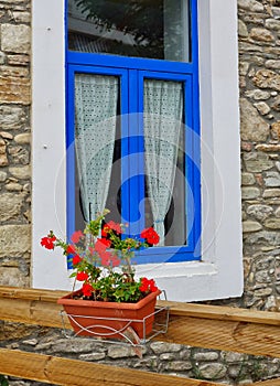 White and Blue Framed Window on Stone House, Greece