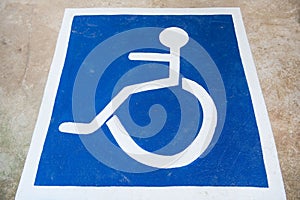 White and blue Handicap symbol car parking of disabled on the floor