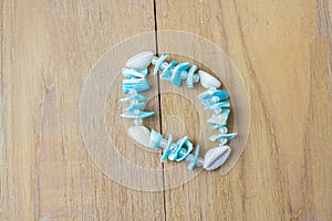 White blue shell bracelet on wooden board
