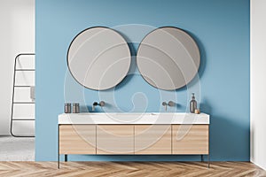 White and blue shower room with round mirrors