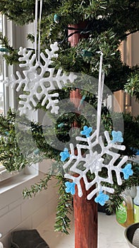 White and Blue Snowflake Ornaments on a Christmas Tree