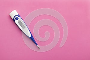 White-blue thermometer with on a pink background