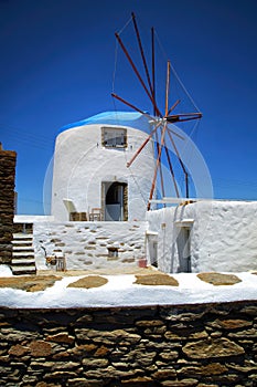 White and blue windmill in Greece in a blue sky