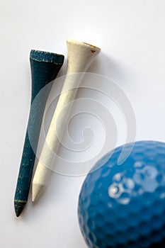 White and blue wooden tee - golf ball on foregroun