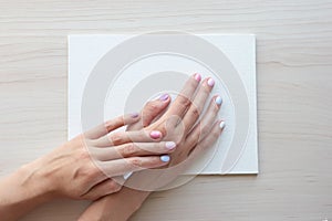 White board with hands for copy space. School office supplies on wooden background. Back to school concept. Top view ready for