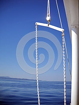White boat chain over blue sky and sea
