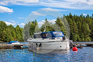 White boat on the docks in the blue lake