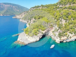 White boat is gliding across a tranquil body of water surrounded by lush vegetation