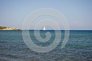 White boat sailing in the open blue aegean sea in