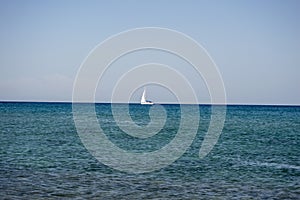 White boat sailing in the open blue aegean sea