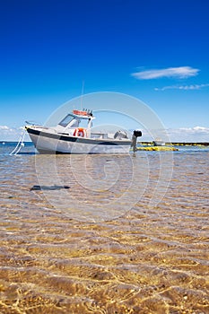 White boat on sand