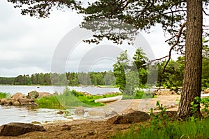 White boat on sandy shore. Hamina camping, Finland, Suomi photo