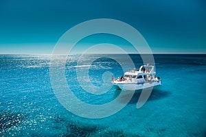 White boat in the sea with clean transparant blue water photo