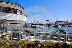 White boats and yachts at the docks in the harbor with deep blue ocean water and blue sky at Burton Chace Park