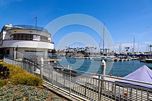 White boats and yachts at the docks in the harbor with deep blue ocean water and blue sky at Burton Chace Park