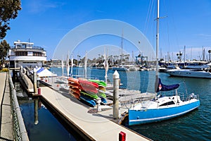 White boats and yachts at the docks in the harbor with deep blue ocean water and blue sky at Burton Chace Park