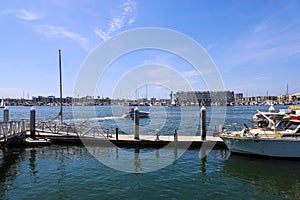 White boats and yachts at the docks in the harbor with deep blue ocean water and blue sky at Burton Chace Park