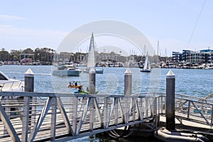 White boats and yachts at the docks in the harbor with deep blue ocean water and blue sky at Burton Chace Park