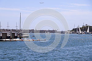 White boats and yachts at the docks in the harbor with deep blue ocean water and blue sky at Burton Chace Park