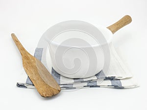 White boiling pan and wooden spatula on a fabric