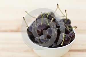 White bolw with ripe cherries