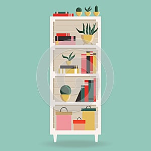 White bookshelf with books and plants. Element of home interior design.