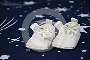 White bootees pair for baby baptism party shower in Romanian tradition celebration