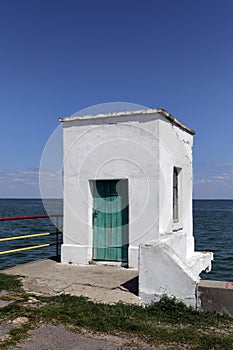 White booth at seaside in bright sunlight