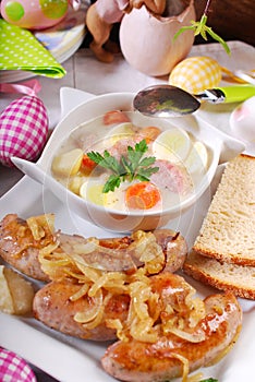 White borscht and roasted sausage on easter table