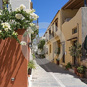 The white bougainvillea, the colorful houses, the lanterns and the many planters characterize the cozy alleys in the old town of R photo