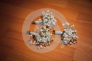 White bouquets of flowers on the brown gackground