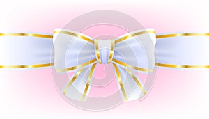 White bow on ribbon with golden edging.